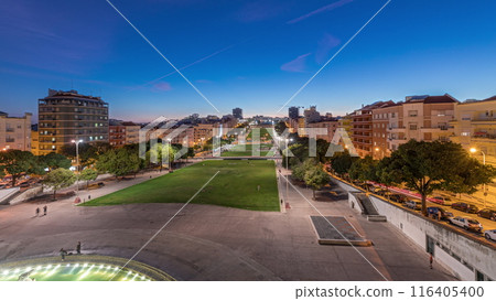 Panorama showing lawn at Alameda Dom Afonso Henriques and the Luminous Fountain aerial day to night timelapse in Lisbon. 116405400
