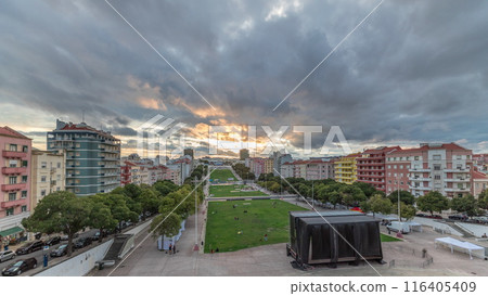 Panorama showing aerial view of Jardim da Alameda in Lisbon with the Luminous Fountain timelapse during sunset. 116405409
