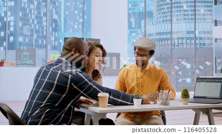 Brokers team and entrepreneur discussing a real estate potential, evaluating architectural plans and negotiating contract terms for renting a high class office space. Rental agreement at desk. Camera 116405528