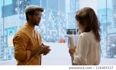 Business woman meeting with realtor to review blueprints for high class office relocation. Entrepreneur negotiating contract deal for rental agreement, plans to invest in property. Camera A. Business woman meeting with realtor to review blueprints for high class office relocation. Entrepreneur negotiating contract deal for rental agreement, plans to invest in property. Camera A. 116405537