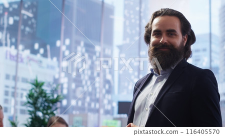 Portrait of happy financial advisor meeting with clients to recommend financial products and investments such as stocks and bonds. Cheerful agent informs family of best investment strategies, camera B 116405570