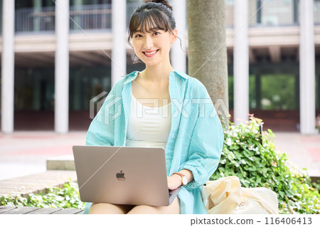 Female college student using a laptop Female college student using a laptop 116406413