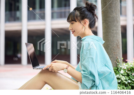 Female college student using a laptop 116406416