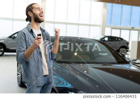 Confident young man in casual clothes near the car 116406431