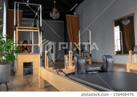 Modern Pilates studio with bright, spacious windows for exercise and wellbeing Modern Pilates studio with bright, spacious windows for exercise and wellbeing 116406476
