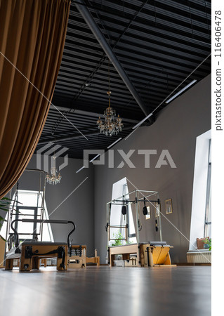 Modern Pilates studio with bright, spacious windows for exercise and wellbeing Modern Pilates studio with bright, spacious windows for exercise and wellbeing 116406478