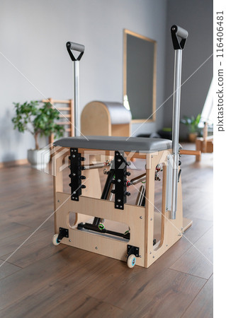 Professional equipment for Pilates studio. Pilates reformer chair for Pilates gym exercise. Details. Correction of musculoskeletal system, beautiful body. Professional equipment for Pilates studio. Pilates reformer chair for Pilates gym exercise. Details. Correction of musculoskeletal system, beautiful body. 116406481