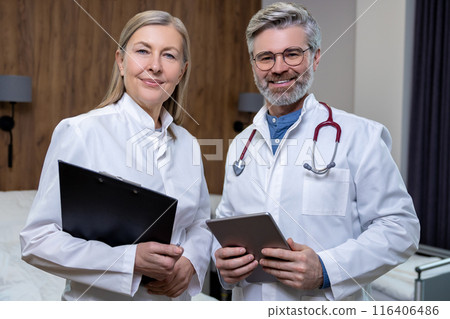 Doctors in lab coats standing close and looking confident Doctors in lab coats standing close and looking confident 116406486