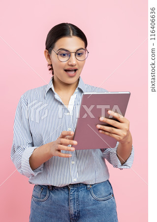 Brunette woman using digital tablet for internet browsing 116406636