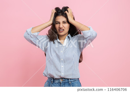 Irritated Indian woman screaming with despair keeps hands on head Irritated Indian woman screaming with despair keeps hands on head 116406706