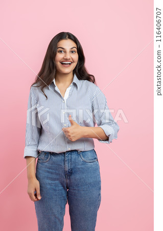 Amazed Indian woman showing approved gesture thumb up Amazed Indian woman showing approved gesture thumb up 116406707