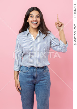 Excited amazed Indian woman indicating upwards having idea 116406711