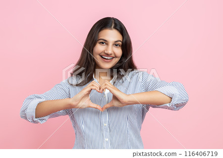 Delighted Indian woman showing heart shape with hands Delighted Indian woman showing heart shape with hands 116406719
