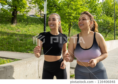 Body positive plus-size plump woman athlete jogging in fitness outfit Body positive plus-size plump woman athlete jogging in fitness outfit 116406848