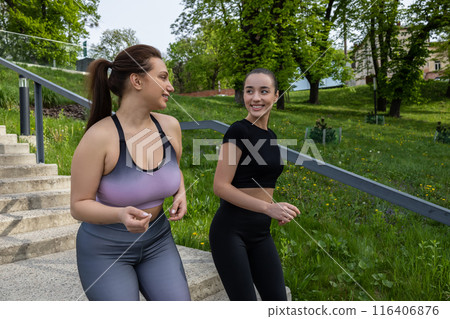 Body positive plus-size plump woman athlete jogging in fitness outfit Body positive plus-size plump woman athlete jogging in fitness outfit 116406876