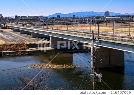 Scenery of a bridge over the Tama River and a train 116407069