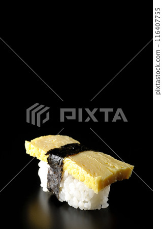 Egg nigiri sushi photographed against a black background 116407755