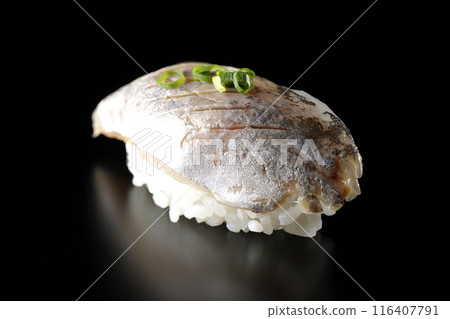 Horse mackerel nigiri sushi photographed against a black background Horse mackerel nigiri sushi photographed against a black background 116407791