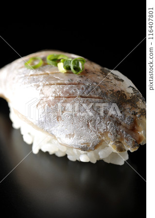 Horse mackerel nigiri sushi photographed against a black background 116407801