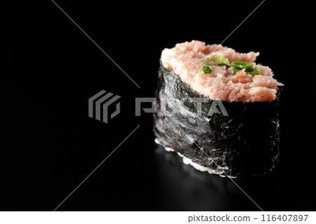 Negitoro gunkanmaki photographed against a black background Negitoro gunkanmaki photographed against a black background 116407897