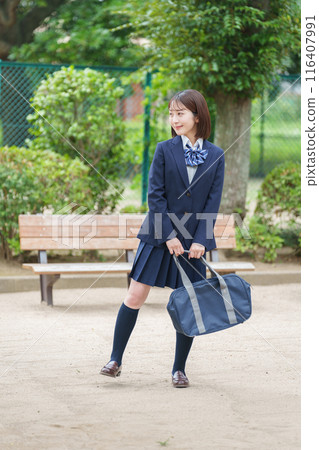 Smiling female high school student full body 116407991