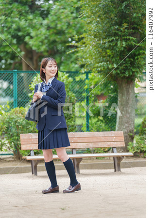 Smiling female high school student full body Smiling female high school student full body 116407992