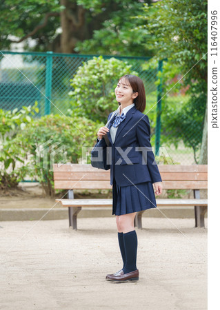 Smiling female high school student full body 116407996
