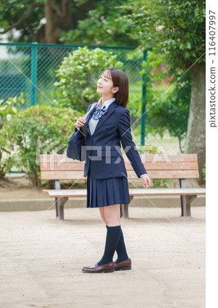 Smiling female high school student full body 116407997