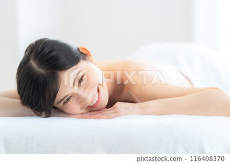 A middle-aged woman doing skin care at a beauty salon A middle-aged woman doing skin care at a beauty salon 116408370