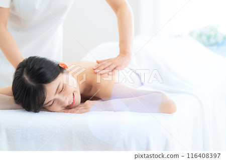 A middle-aged woman doing skin care at a beauty salon A middle-aged woman doing skin care at a beauty salon 116408397