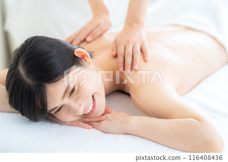 A middle-aged woman doing skin care at a beauty salon A middle-aged woman doing skin care at a beauty salon 116408436