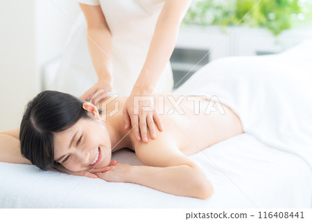 A middle-aged woman doing skin care at a beauty salon A middle-aged woman doing skin care at a beauty salon 116408441