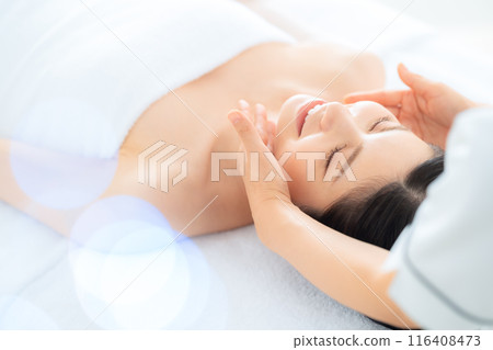 A middle-aged woman doing skin care at a beauty salon A middle-aged woman doing skin care at a beauty salon 116408473