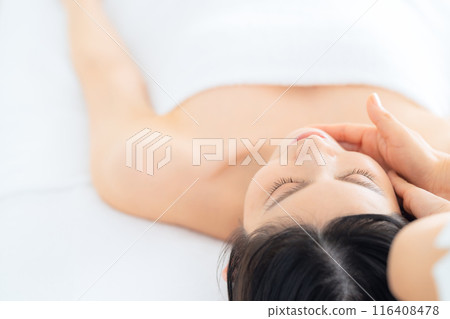 A middle-aged woman doing skin care at a beauty salon A middle-aged woman doing skin care at a beauty salon 116408478