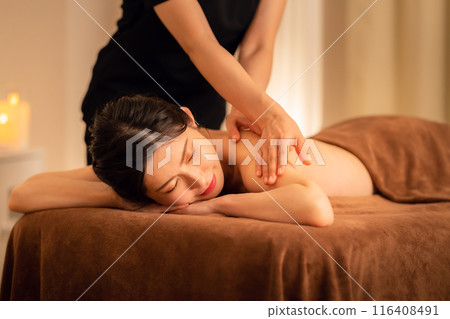A middle-aged woman doing skin care at a beauty salon A middle-aged woman doing skin care at a beauty salon 116408491