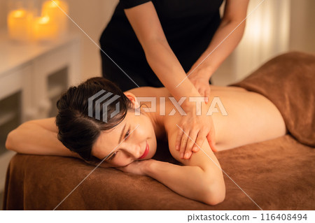 A middle-aged woman doing skin care at a beauty salon A middle-aged woman doing skin care at a beauty salon 116408494