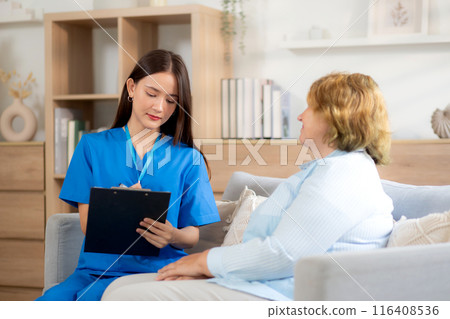 Caregiver sitting on sofa checkup and diagnostic with elderly woman patient about health. 116408536