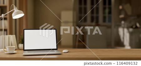 A laptop computer with a white-screen mockup on a wooden tabletop in a contemporary cosy apartment. A laptop computer with a white-screen mockup on a wooden tabletop in a contemporary cosy apartment. 116409132