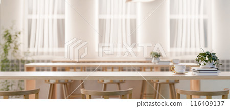 A copy space for displaying products on a wooden tabletop in a minimal bright cafe co-working space. A copy space for displaying products on a wooden tabletop in a minimal bright cafe co-working space. 116409137