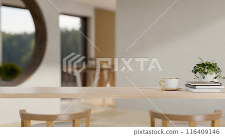 A wooden table in a cozy contemporary room with decor and a copy space for display products. 116409146