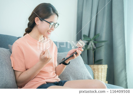 Asian woman having feels good after buying somethings online by credit card. Asian woman having feels good after buying somethings online by credit card. 116409508