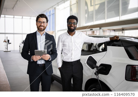 Dealer sells electric SUV to businessman in car dealership 116409570