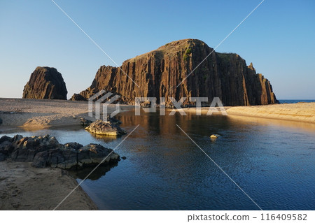 A view of a huge monolith with columnar joints towering against a clear blue sky Ver4 A view of a huge monolith with columnar joints towering against a clear blue sky Ver4 116409582