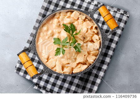 homemade chicken stroganoff in pan on cement table homemade chicken stroganoff in pan on cement table 116409736