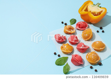 Colored dumplings on wooden white background, close up Colored dumplings on wooden white background, close up 116409839