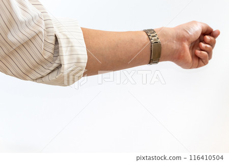 A man's arm with his shirt sleeves rolled up 116410504