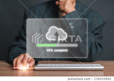 A businessman in a suit uploads data to the cloud, with a progress bar showing 45% completion on a transparent screen. A businessman in a suit uploads data to the cloud, with a progress bar showing 45% completion on a transparent screen. 116410992