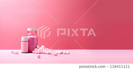 Healthcare concept featuring various medicines on a pink background, suitable for banners and advertisements. Medicine and pills on a pink background 116411121