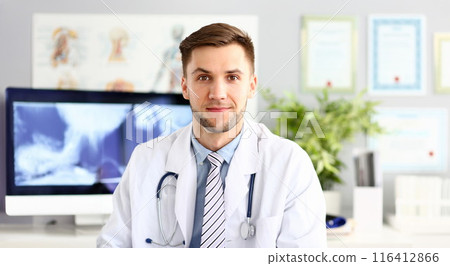 Handsome smiling medicine doctor sitting in office 116412866