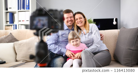 Young happy family sit on couch making photo session portrait 116413080